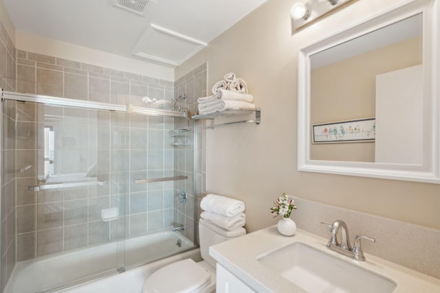 full bathroom with vanity, shower / bath combination with glass door, and toilet