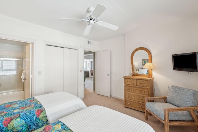 bedroom with ceiling fan, a closet, and light carpet