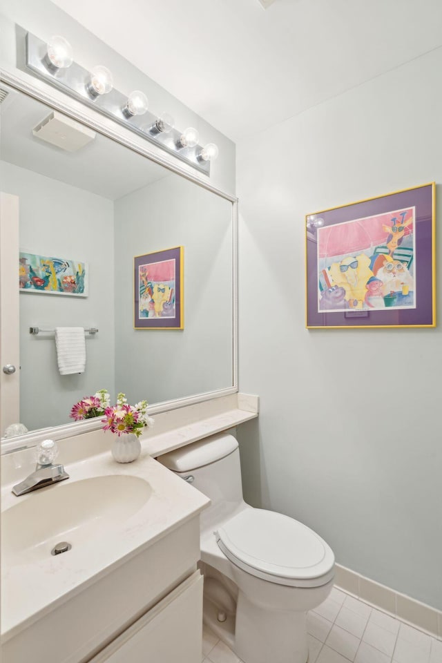 bathroom with tile patterned floors, vanity, and toilet