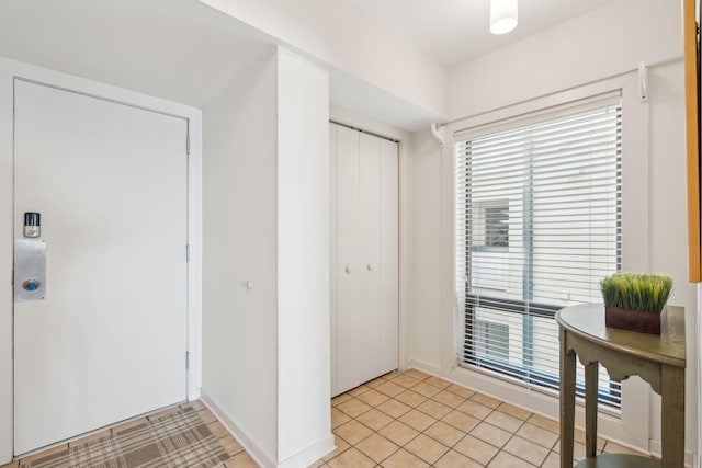 foyer entrance with light tile patterned floors