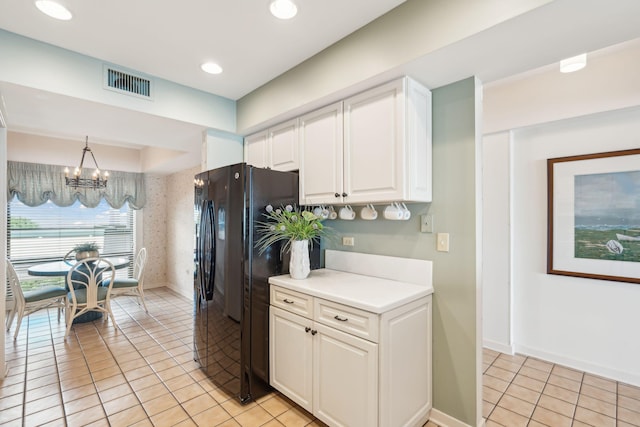 kitchen with light tile patterned floors, an inviting chandelier, pendant lighting, and white cabinets