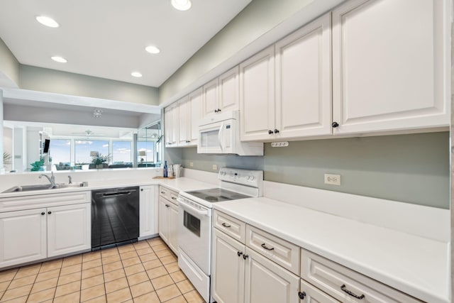 kitchen featuring sink, white appliances, white cabinetry, and light tile patterned floors