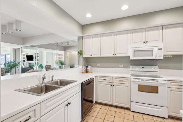 kitchen with light tile patterned floors, white appliances, and white cabinets