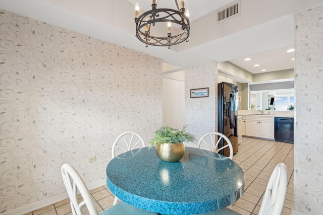 tiled dining area featuring sink and a chandelier