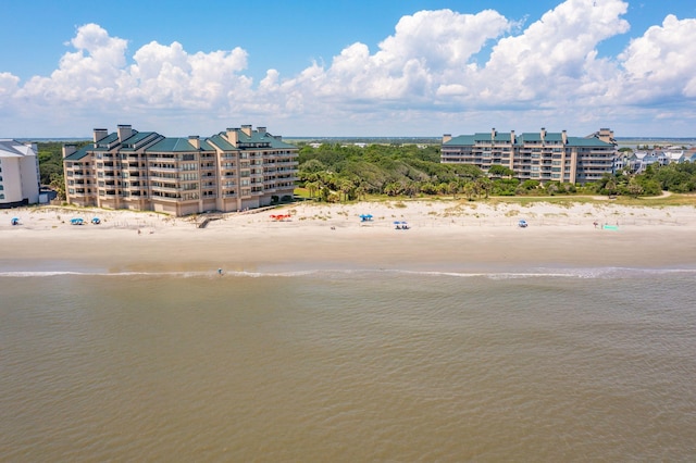 drone / aerial view featuring a beach view and a water view