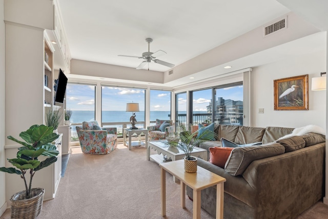 carpeted living room featuring ceiling fan and a healthy amount of sunlight