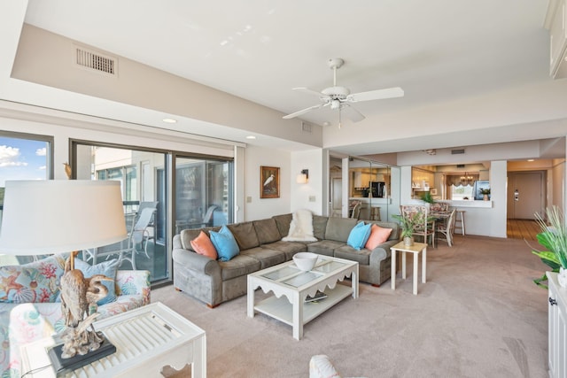 carpeted living room featuring ceiling fan