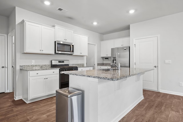 1032 Peridote Way, Ladson, SC 29456 - kitchen with appliances with stainless steel finishes, dark wood-type flooring, light stone counters, white cabinets, and recessed lighting