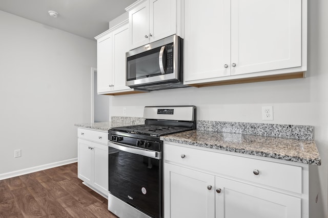 1032 Peridote Way, Ladson, SC 29456 - kitchen with appliances with stainless steel finishes, dark wood-style floors, light stone countertops, and white cabinetry