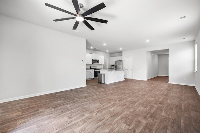 1032 Peridote Way, Ladson, SC 29456 - unfurnished living room featuring wood finished floors, recessed lighting, and a ceiling fan