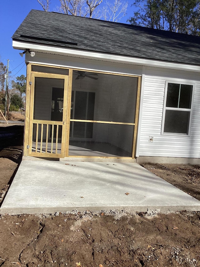 rear view of property featuring a sunroom