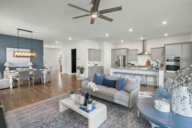 living room with recessed lighting, ceiling fan, and wood finished floors