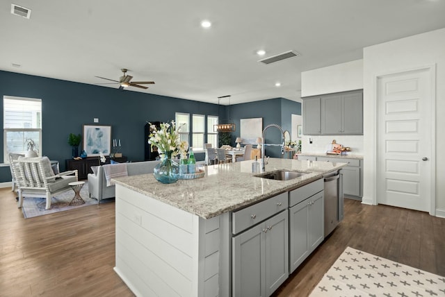 kitchen featuring a sink, visible vents, dark wood-type flooring, and stainless steel dishwasher