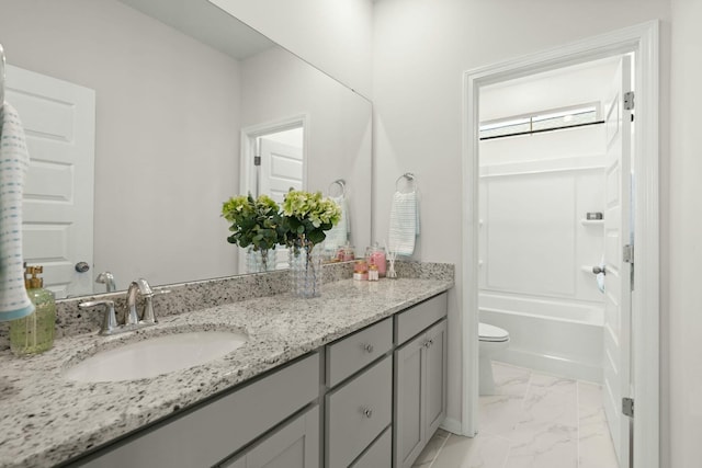 bathroom featuring marble finish floor, shower / bath combination, vanity, and toilet