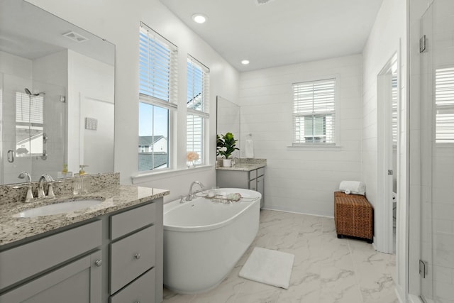 full bath with marble finish floor, a wealth of natural light, visible vents, a stall shower, and a sink