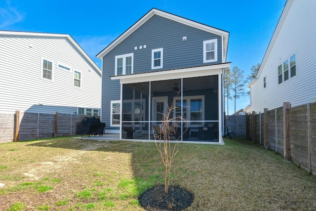 back of house with a sunroom, a fenced backyard, a yard, and ceiling fan