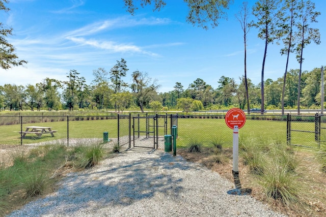 view of gate featuring a yard and fence