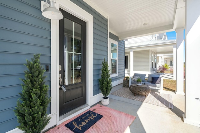 entrance to property with a garage and covered porch