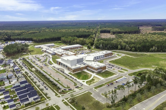 birds eye view of property featuring a wooded view