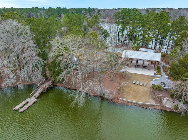 drone / aerial view featuring a water view and a wooded view