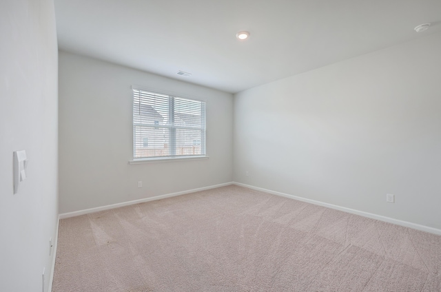 empty room featuring light carpet