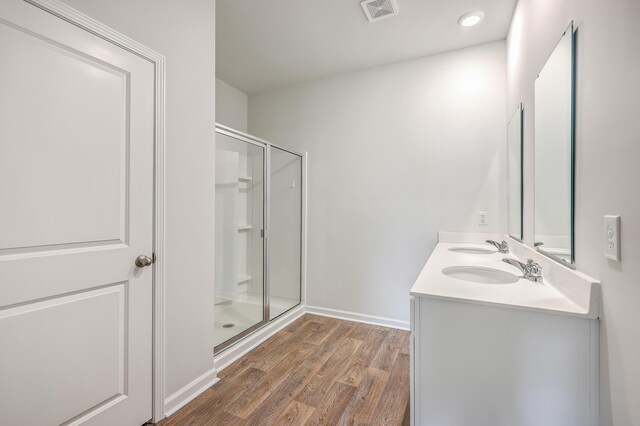 bathroom with vanity, hardwood / wood-style floors, and walk in shower