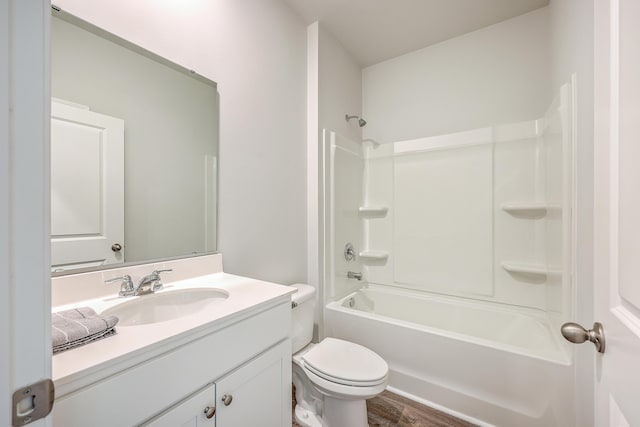 full bathroom with toilet,  shower combination, hardwood / wood-style floors, and vanity