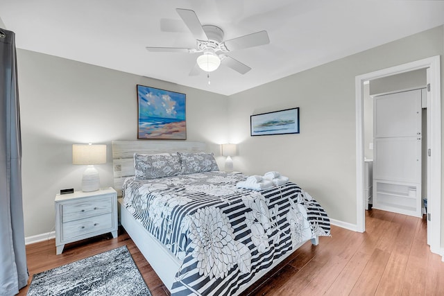 bedroom featuring dark wood-style floors, ceiling fan, and baseboards