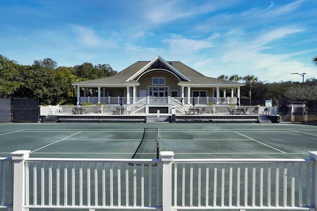 view of tennis court featuring fence