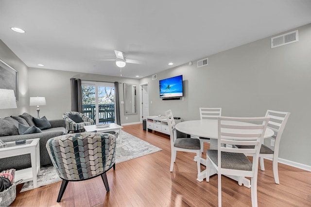 living room with recessed lighting, visible vents, ceiling fan, and wood finished floors