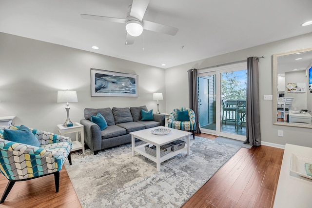 living room featuring a ceiling fan, recessed lighting, baseboards, and wood finished floors