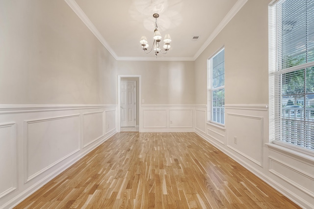 1308 Wild Olive Dr, Mount Pleasant, SC 29464 - unfurnished dining area featuring a chandelier, light wood-type flooring, ornamental molding, a decorative wall, and a wainscoted wall