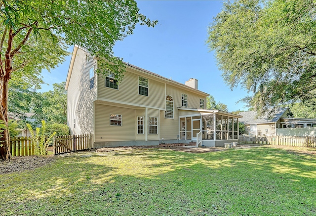 1308 Wild Olive Dr, Mount Pleasant, SC 29464 - rear view of property featuring a sunroom, a chimney, and a fenced backyard