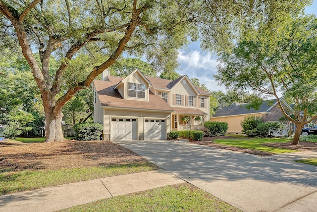 1308 Wild Olive Dr, Mount Pleasant, SC 29464 - traditional home featuring concrete driveway, a garage, a chimney, and a porch