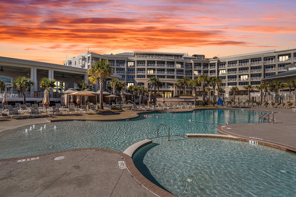 pool at dusk featuring a patio area