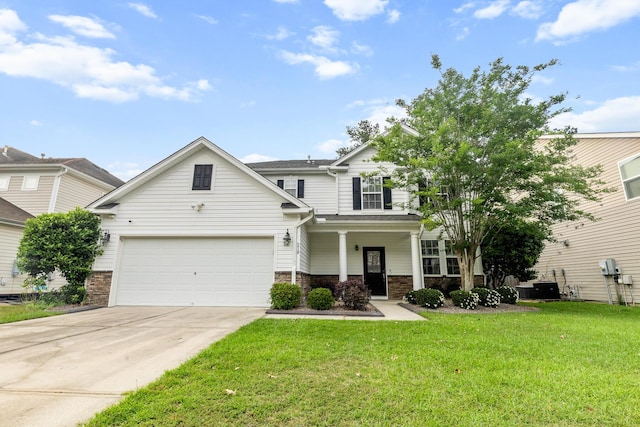 view of front of house with driveway, a front lawn, stone siding, and covered porch