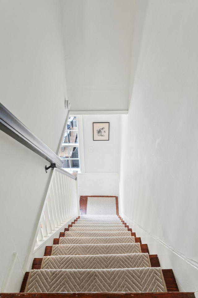 stairway featuring a high ceiling