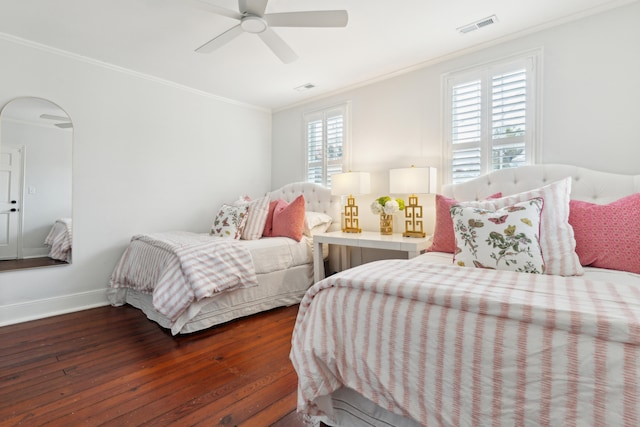 bedroom with ceiling fan, dark hardwood / wood-style flooring, and ornamental molding