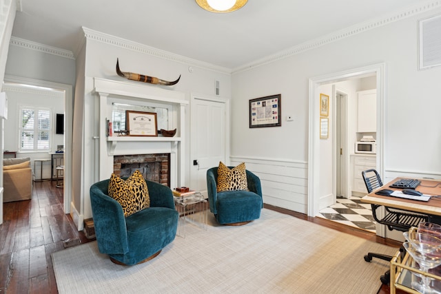 office area featuring hardwood / wood-style flooring, a fireplace, and crown molding