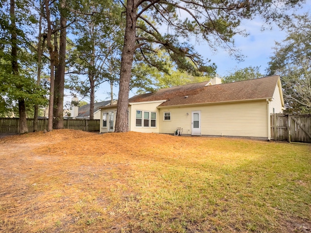 rear view of house with a yard