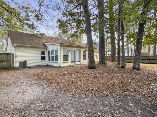 back of house with central AC unit