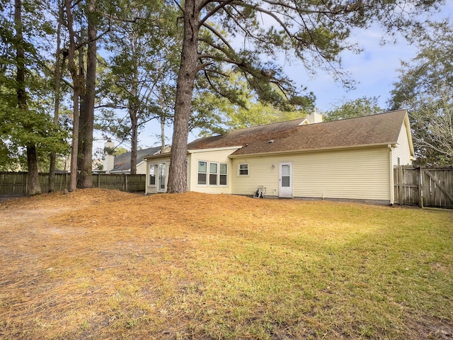 rear view of house with a yard