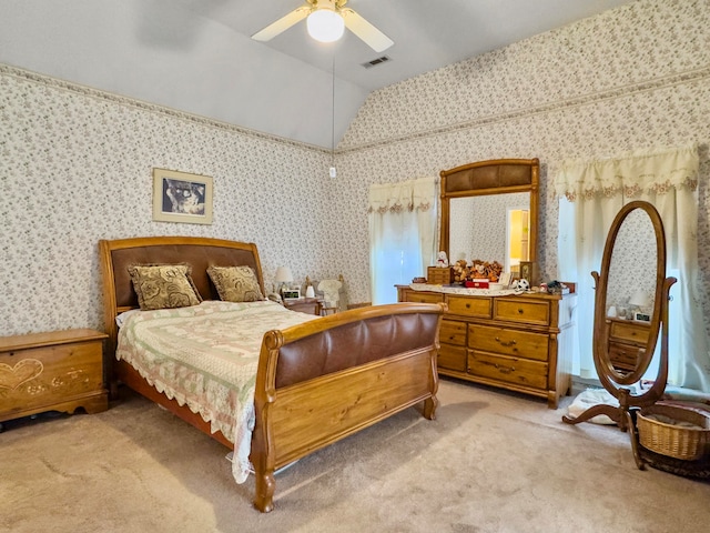 carpeted bedroom with ceiling fan and vaulted ceiling