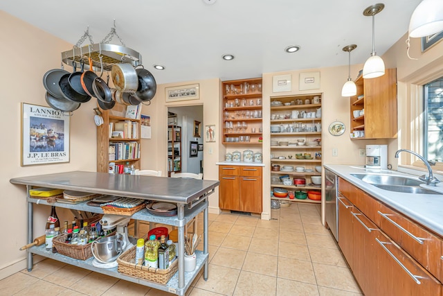 kitchen with pendant lighting, light tile patterned flooring, stainless steel dishwasher, and sink