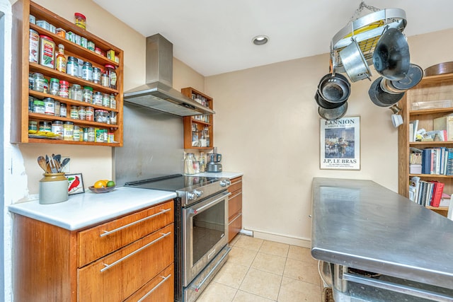 kitchen featuring electric range, light tile patterned floors, and exhaust hood