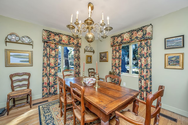 dining space featuring a chandelier and light hardwood / wood-style flooring