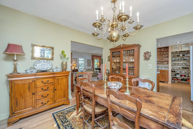 dining room featuring an inviting chandelier and light hardwood / wood-style flooring