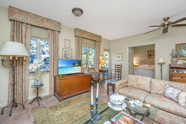 living room with ceiling fan and a healthy amount of sunlight