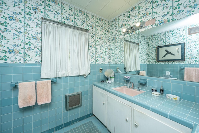 bathroom with tile patterned flooring, vanity, and tile walls