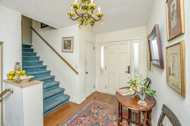 foyer featuring a notable chandelier and dark hardwood / wood-style floors